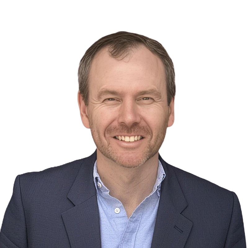 A headshot of a man wearing a blazer and shirt without a tie, smiling at the camera.